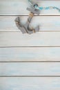 Sea Ã¢â¬â¹Ã¢â¬â¹shells, anchor, blue cord, white fishing net, starfish, pebbles on a white wooden background with place for text,